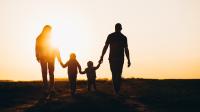 Familie spaziert im Sonnenuntergang