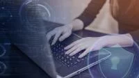Hände an Laptop mit Bildelementen zur Datensicherheit.