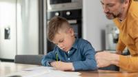 Ein Vater hilft seinem Sohn bei den Hausaufgaben