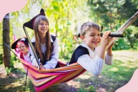 Kinder spielen Piraten in einer Hängematte im Garten