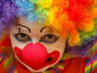 Eine als Clown geschminkte und verkleidete Person