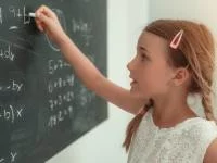 Mädchen schreibt Formel auf Kreidetafel