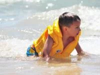 Junge mit Schwimmweste im Wasser