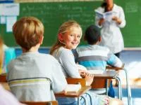 Blondes Mädchen lächelt im Unterricht